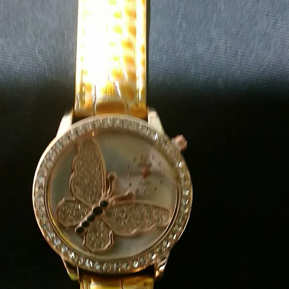 Butterfly watch with gold tone leather band